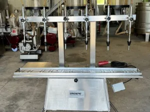 IN-LINE FILLING MACHINE WITH 6 NOZZLES IN STAINLESS STEEL WITH VACUUM, ENOBERG BRAND, SECOND-HAND MACHINE