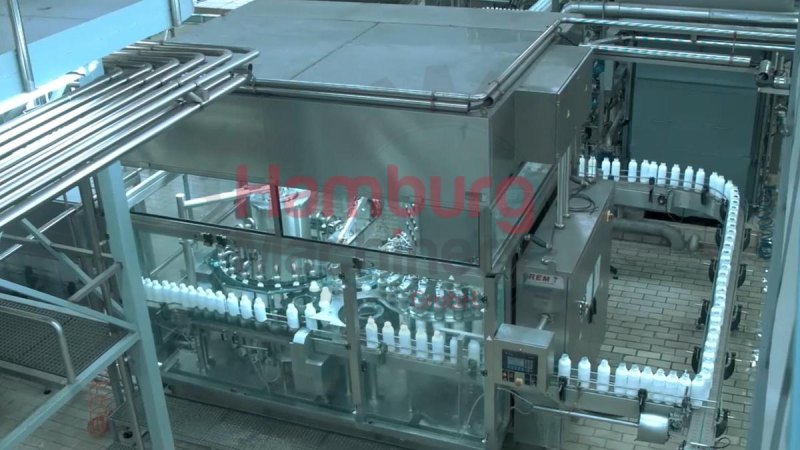 Bottle blowing, filling, closing, sterilizing, labelling and packing line for PE bottles of 1,5 liter with milk - Sidel / Remy / Stork